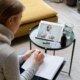 Patient at home taking notes during a video visit with a doctor