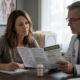 Woman taking notes as a clinician in a white coat reviews a printed leaflet on marijuana and antidepressants with her